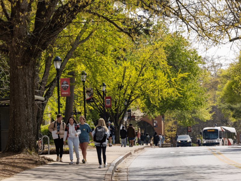 Students walk along Sanford Drive on South Campus.
