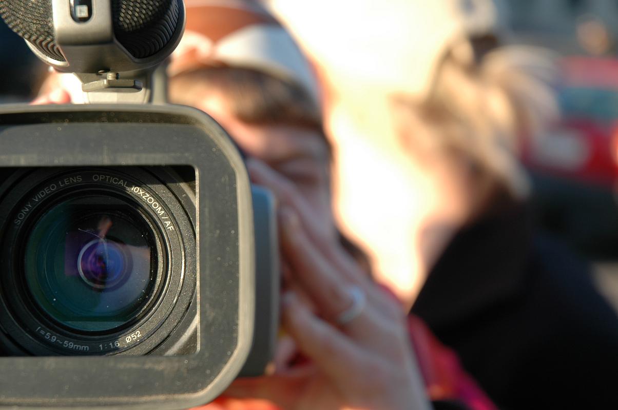 Person holding video camera.